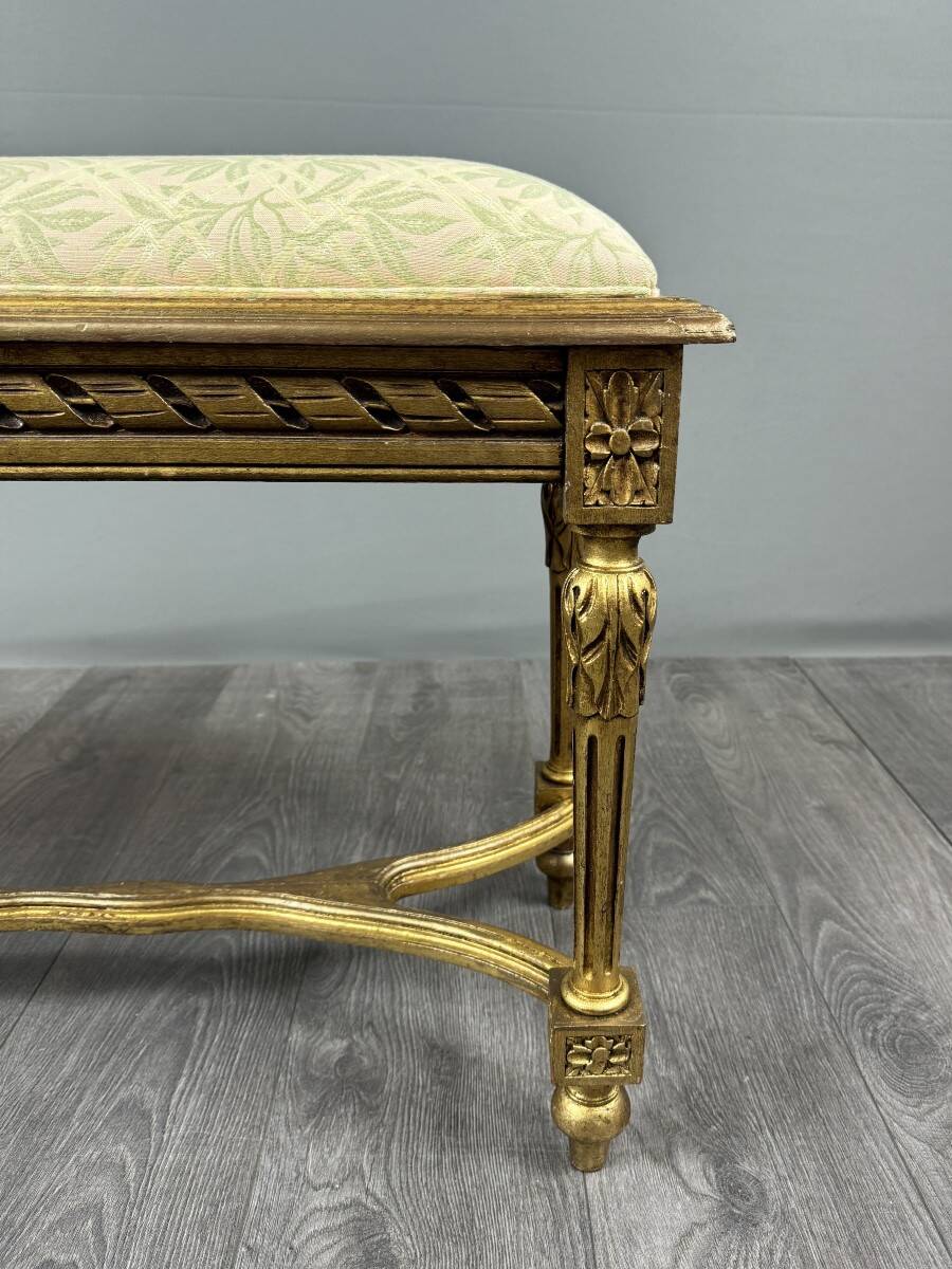 Antique gilded wooden bench in Louis XVI style, 19th century.