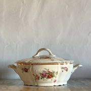 Antique porcelain soup bowl with floral decoration and golden border