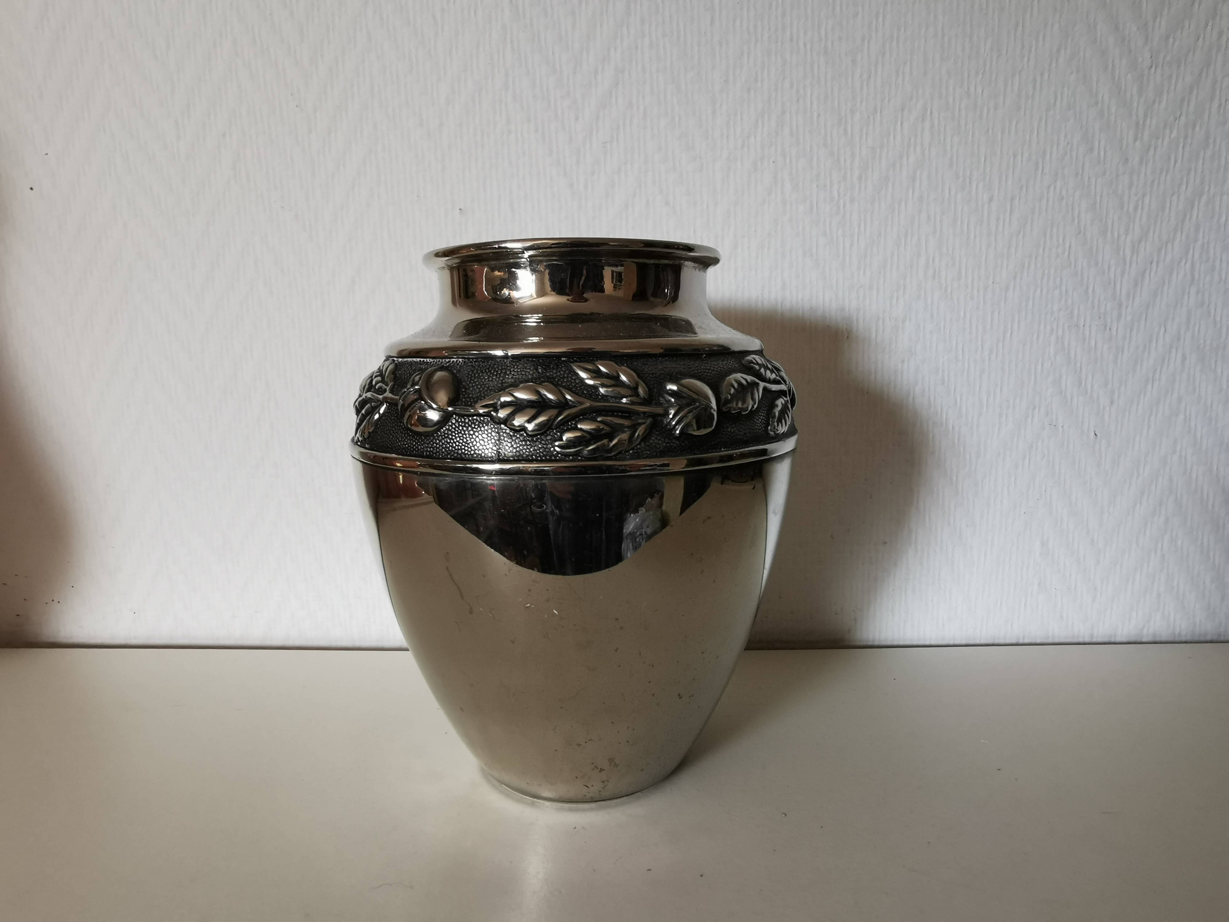metal vase, flowers in relief