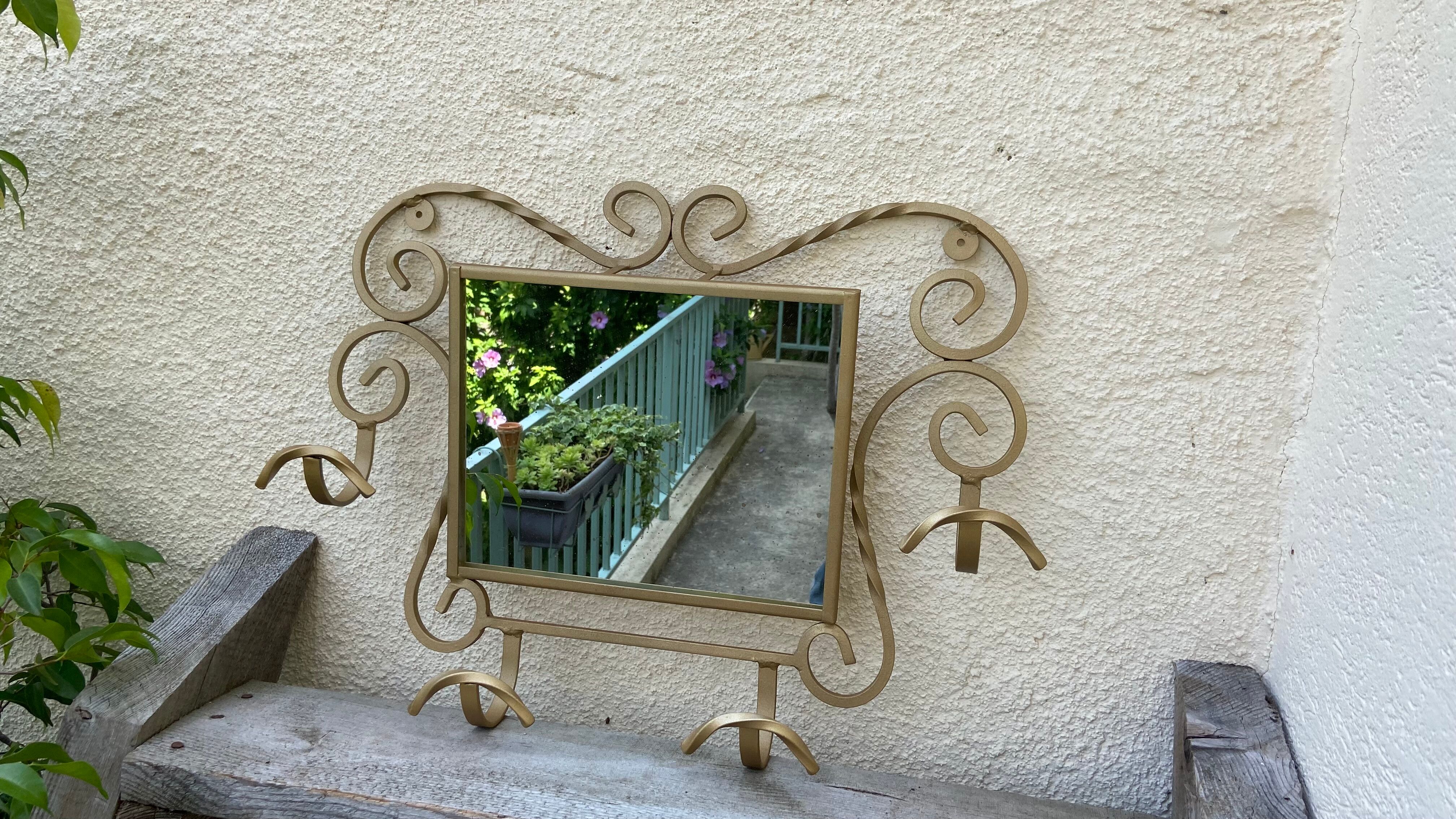Wall-mounted gilded wrought iron coat rack with mirror