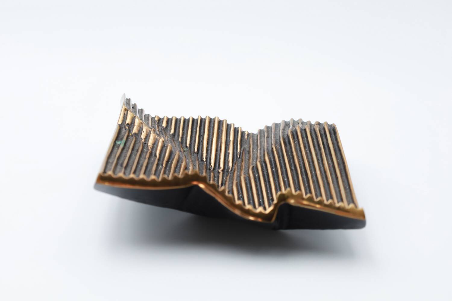 Brutalist bronze pocket emptier