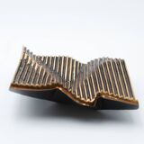 Brutalist bronze pocket emptier