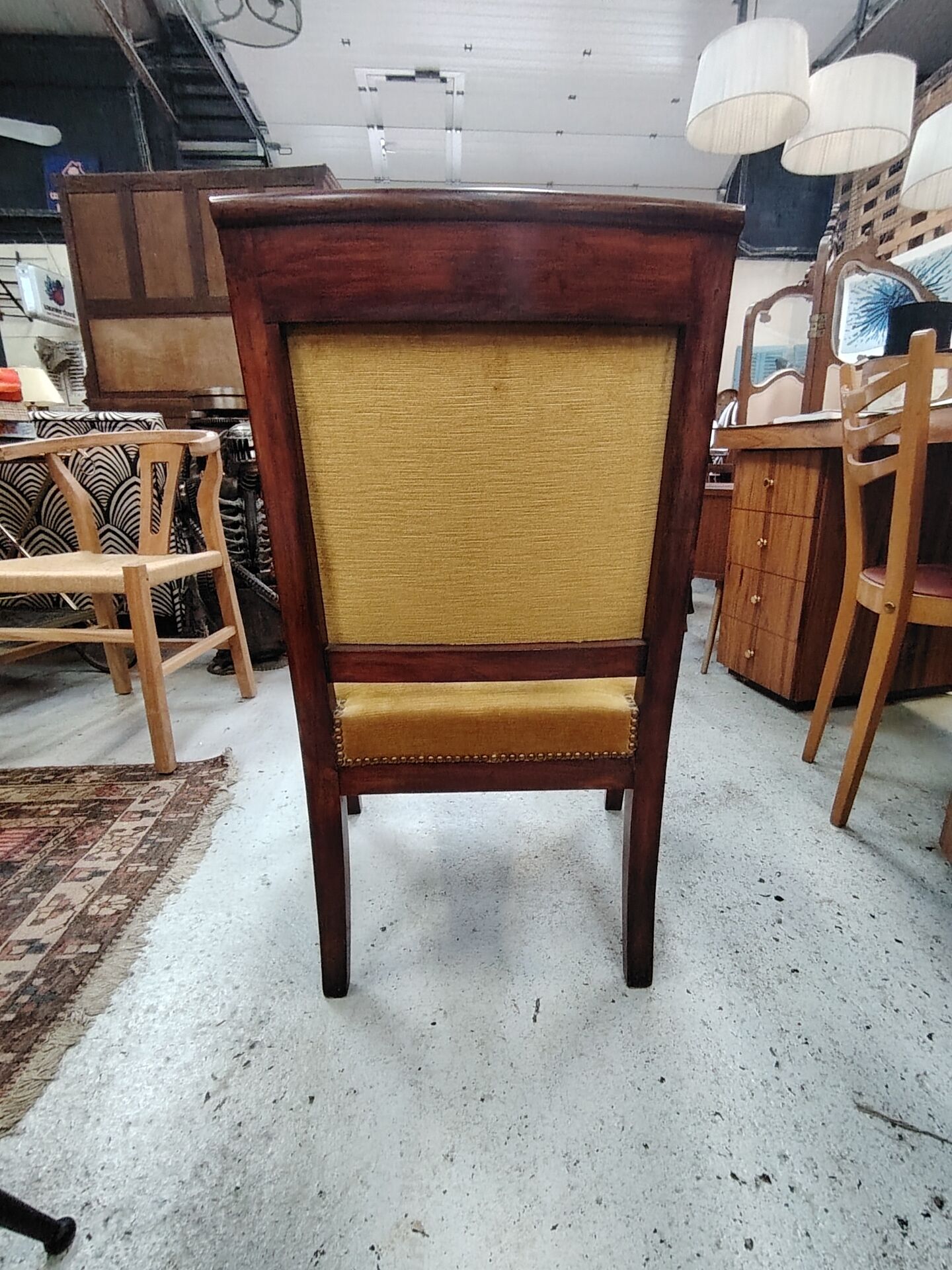 Armchair with scroll arms and sabre legs in mustard velvet, 19th century.