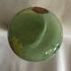 Single flower vase in blown green glass