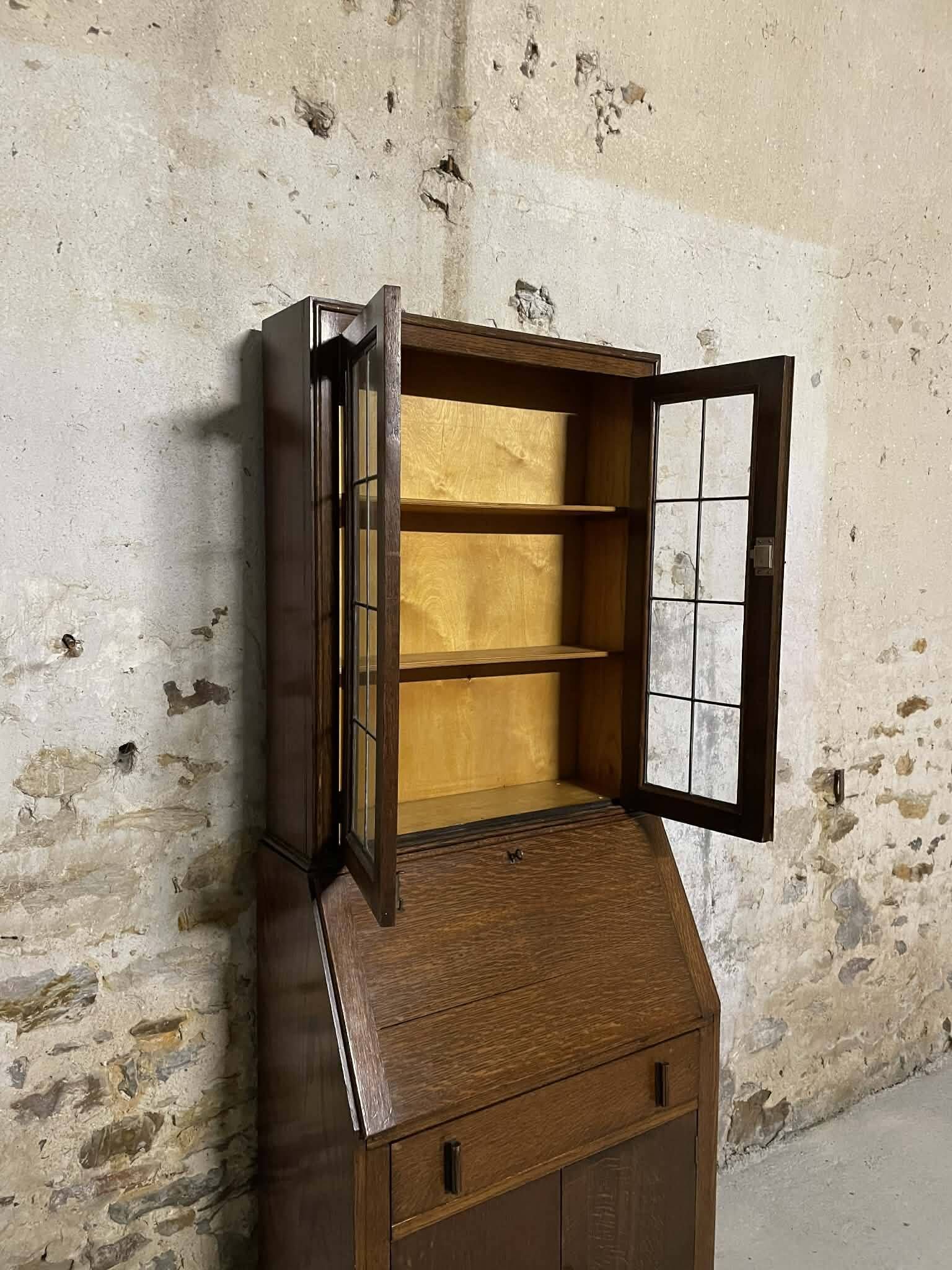 Oak display secretary cabinet with drop-down front, two sections.