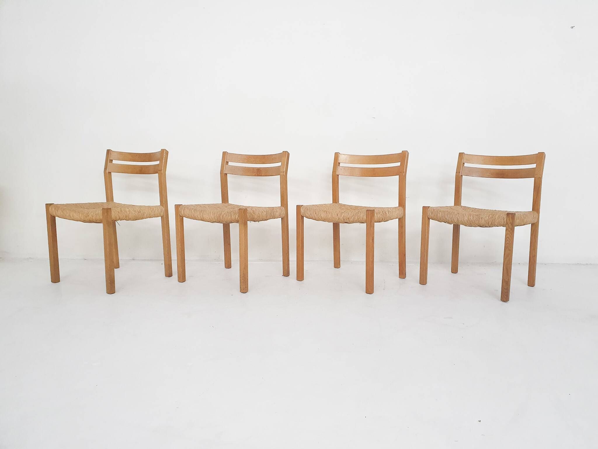 Set of four oak and sisal dining chairs model 401 by JL Moller, Denmark 1970's