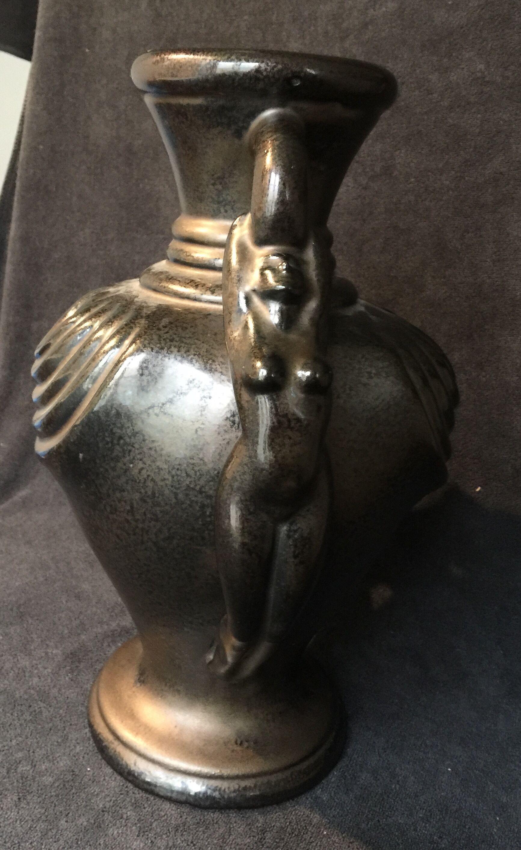 Black ceramic vase caught in naked women's bodies