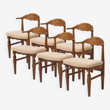 Set of 6 dining chairs by Hennig Kjaernulf reupholstered in sheepskin