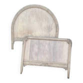 Antique solid wood bed with a carved rounded headboard — Louis XV style