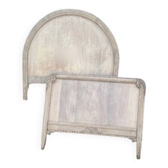 Antique solid wood bed with a carved rounded headboard — Louis XV style