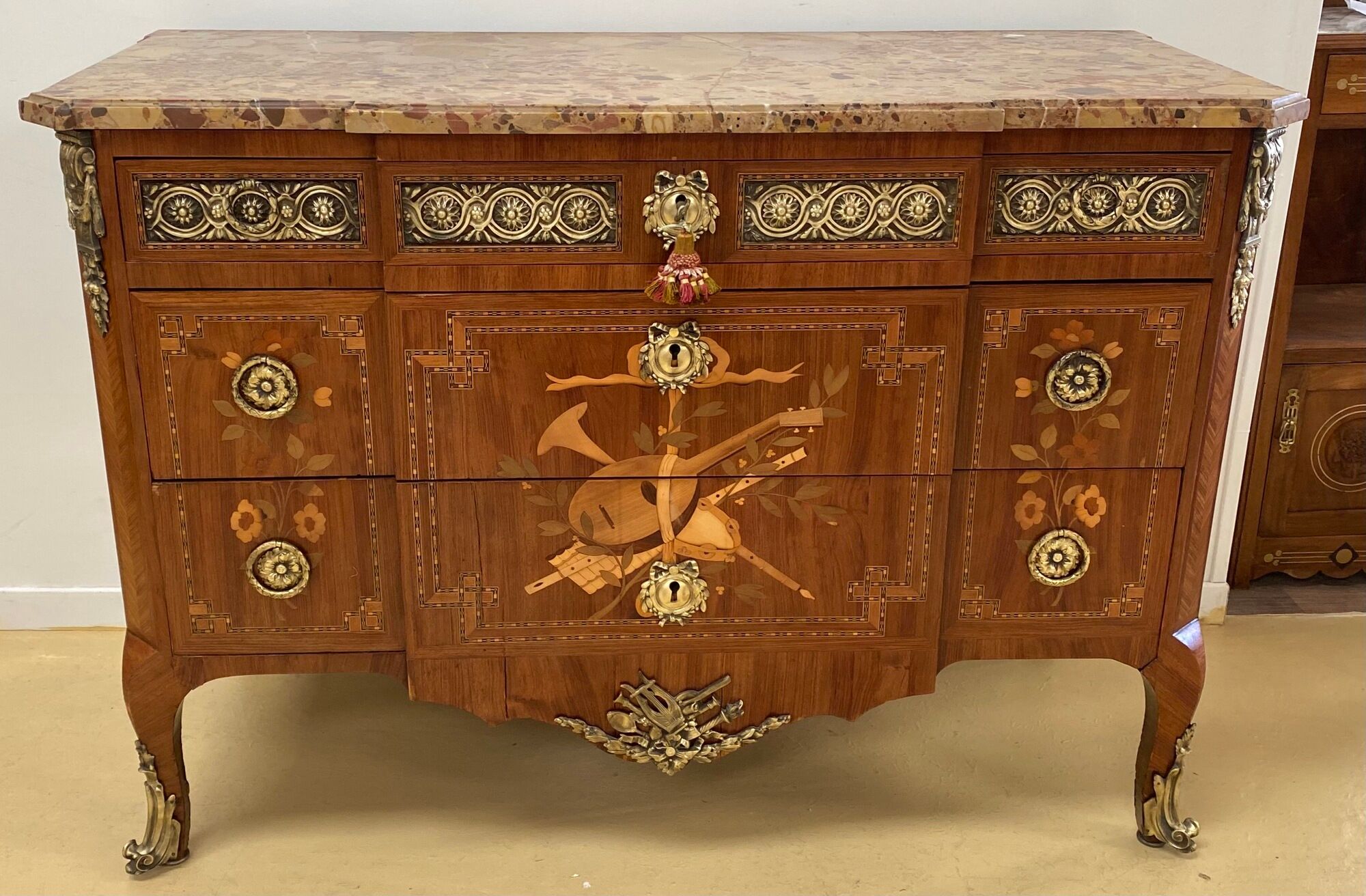 Transition chest of drawers with floral marquetry and music trophy