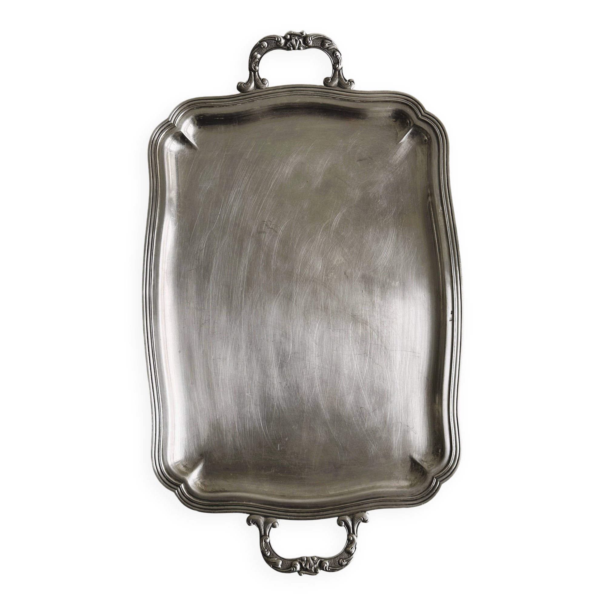 Silver metal serving tray with sculpted handles