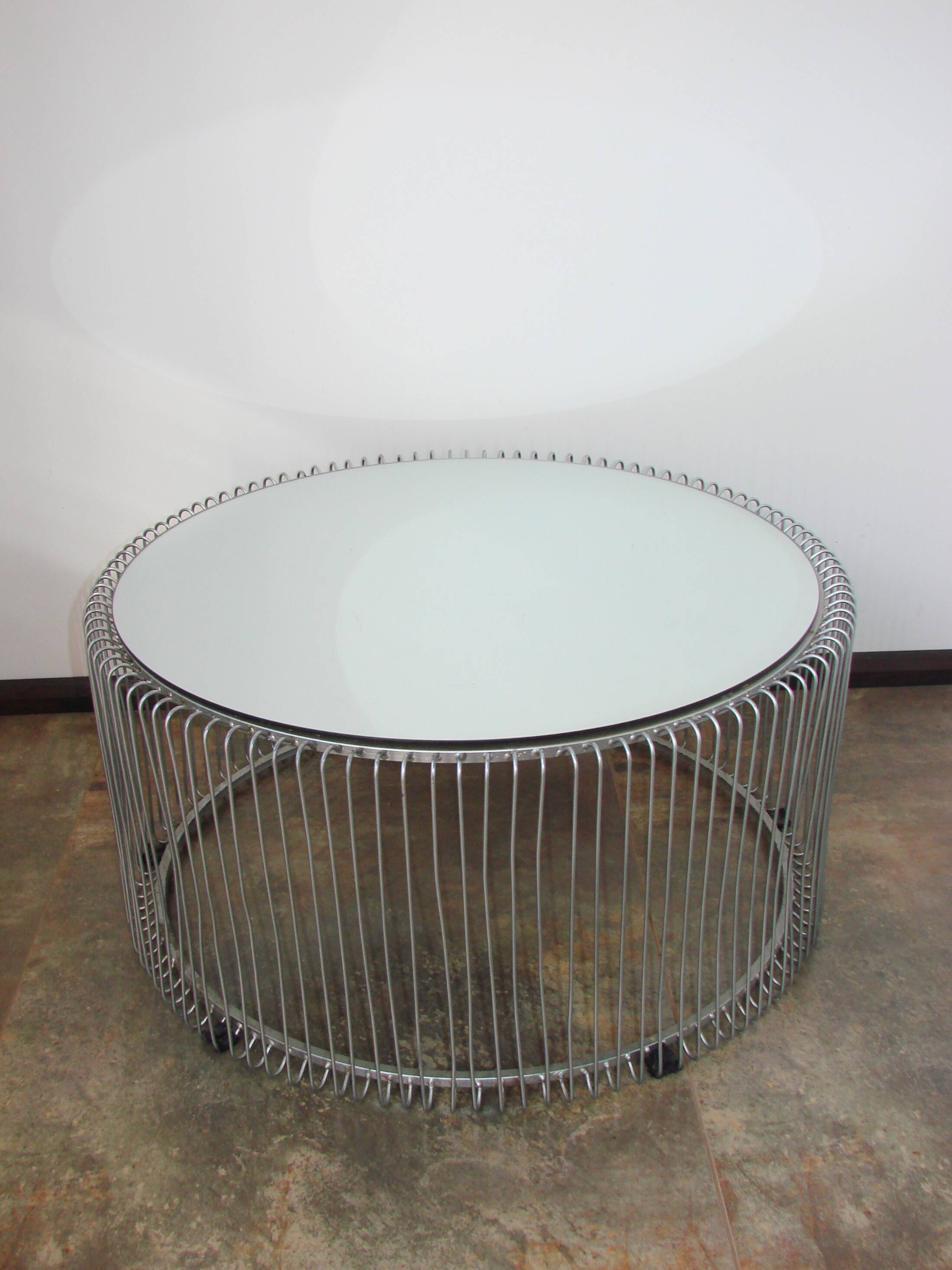 A round coffee table with a mirrored top, from the 1990s.