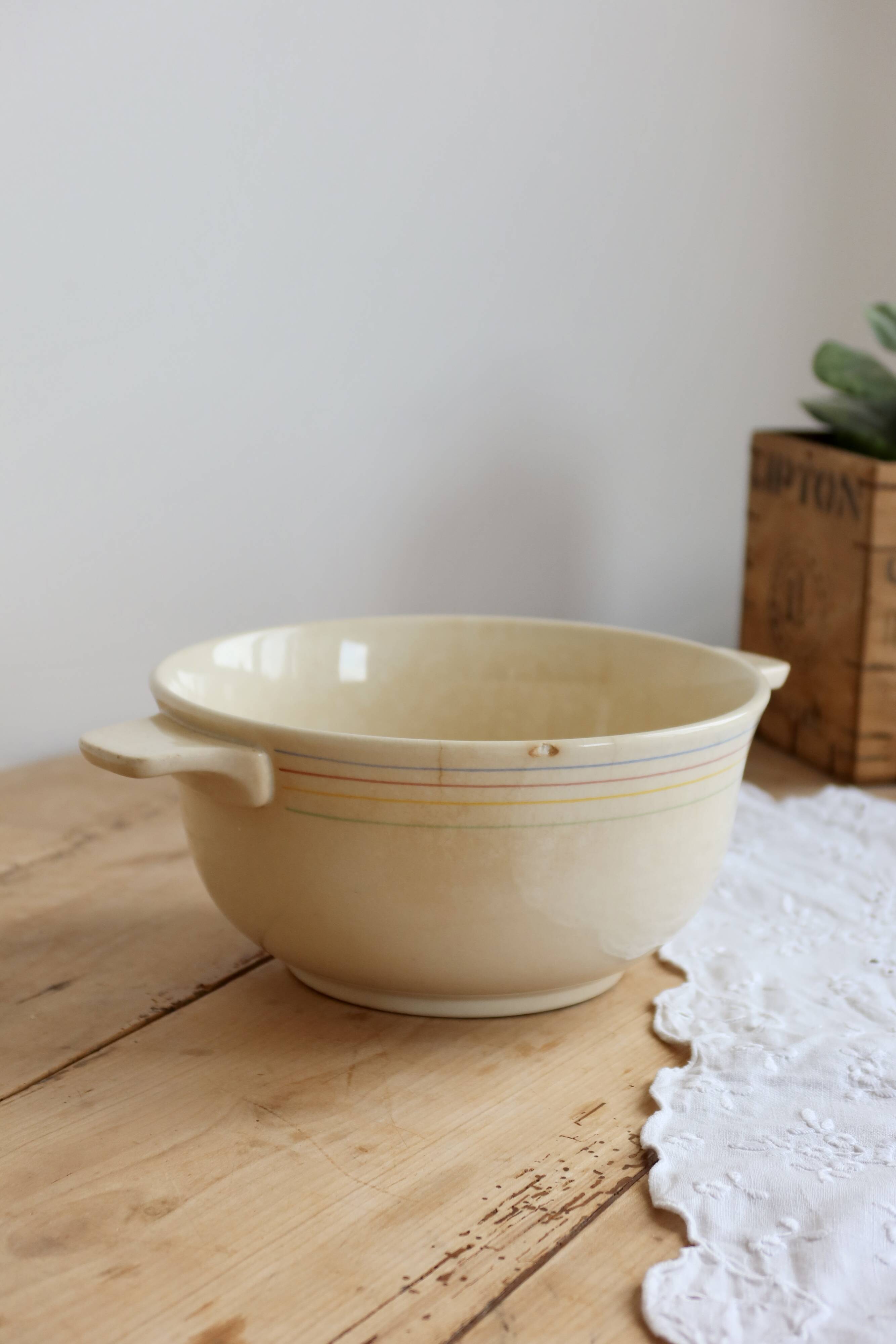 Vintage salad bowl in ivory faience from Chantilly with a rainbow trim.