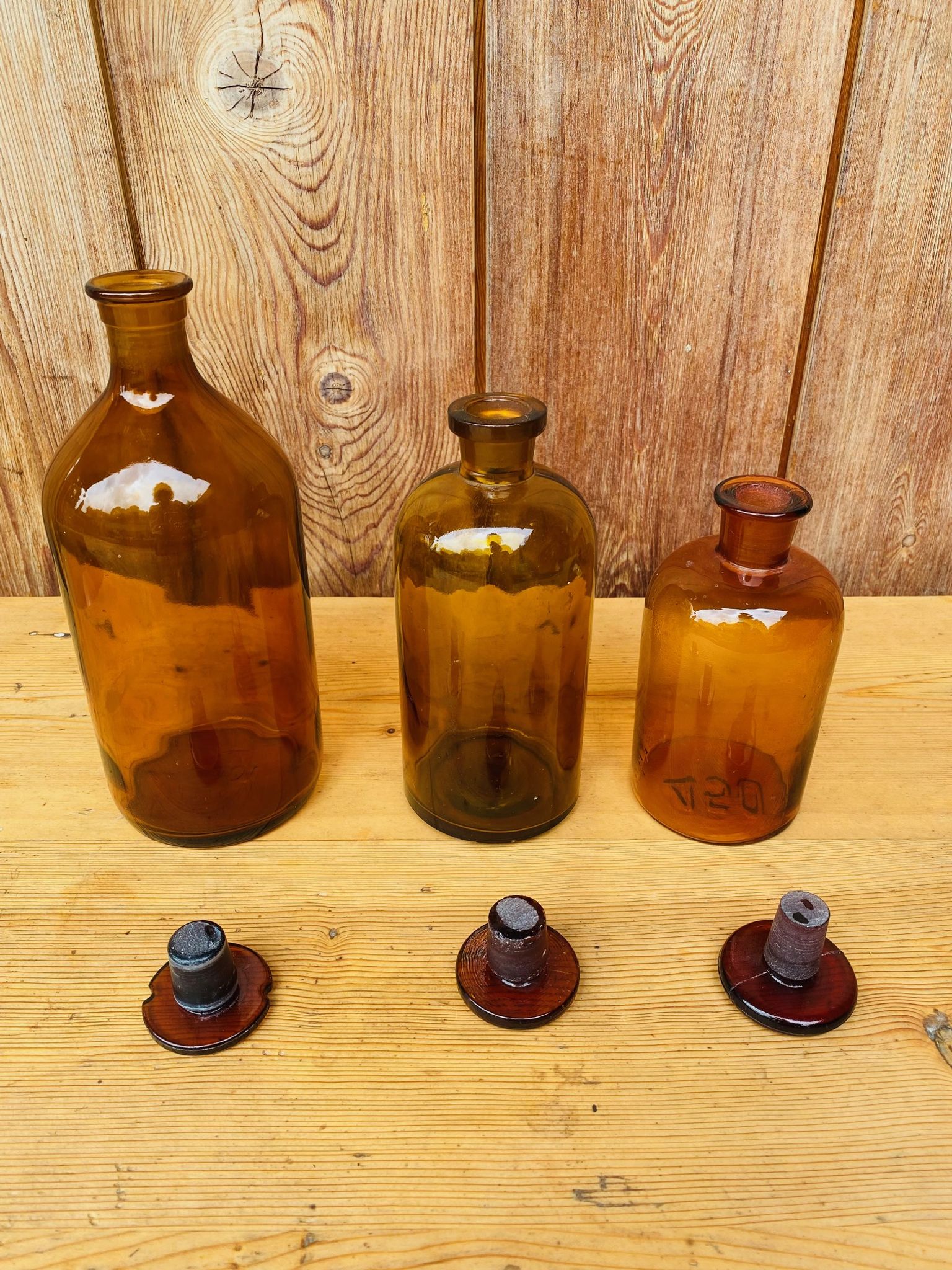 Trio of ancient apothecary bottles of beautiful amber color.