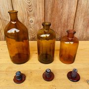 Trio of ancient apothecary bottles of beautiful amber color.