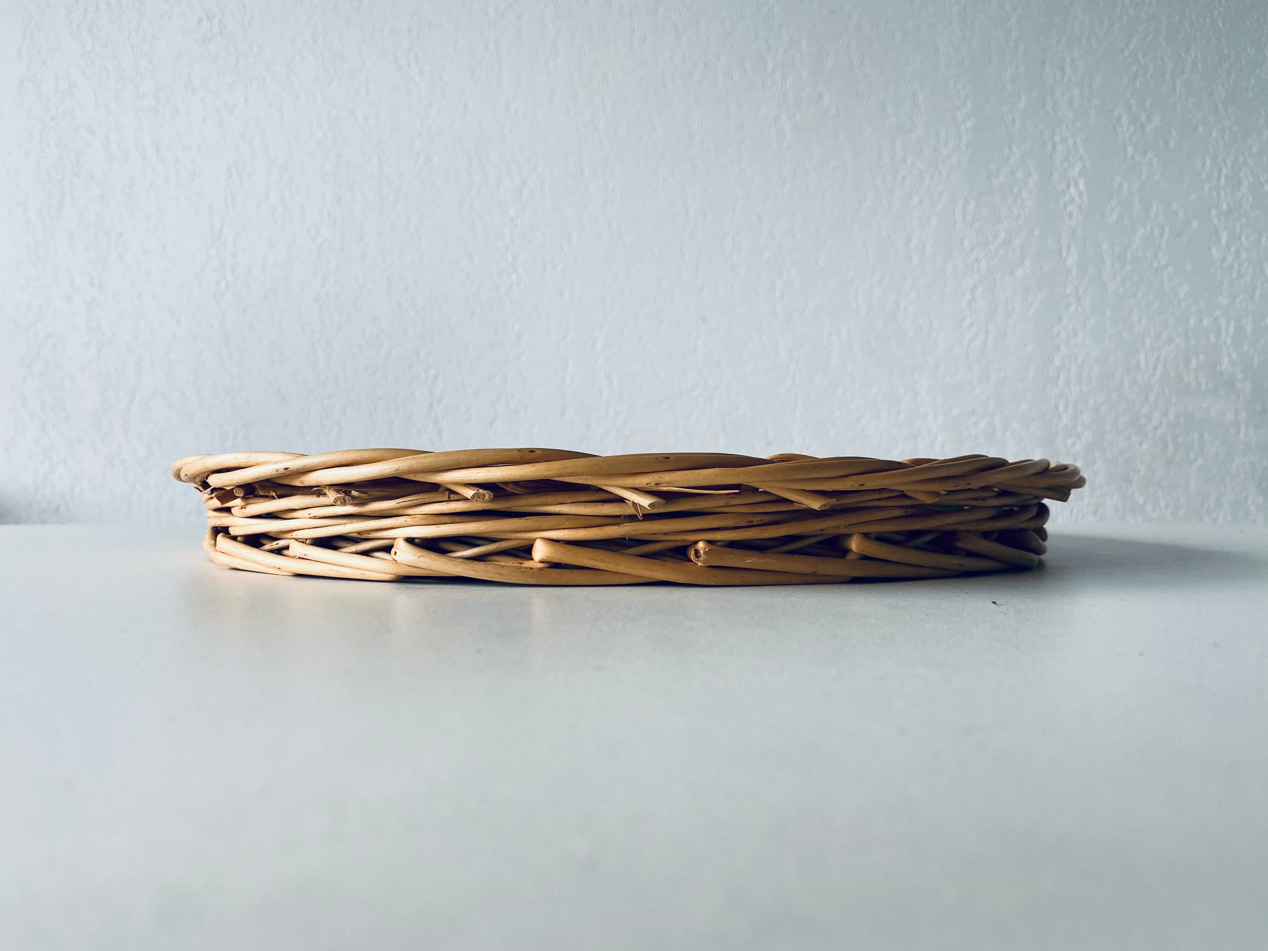 Round mirror in vintage wicker