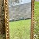 Large antique gilded mirror, wood and stucco gadroons, partially de-mercury