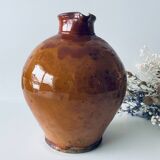 Old pitcher in glazed terracotta