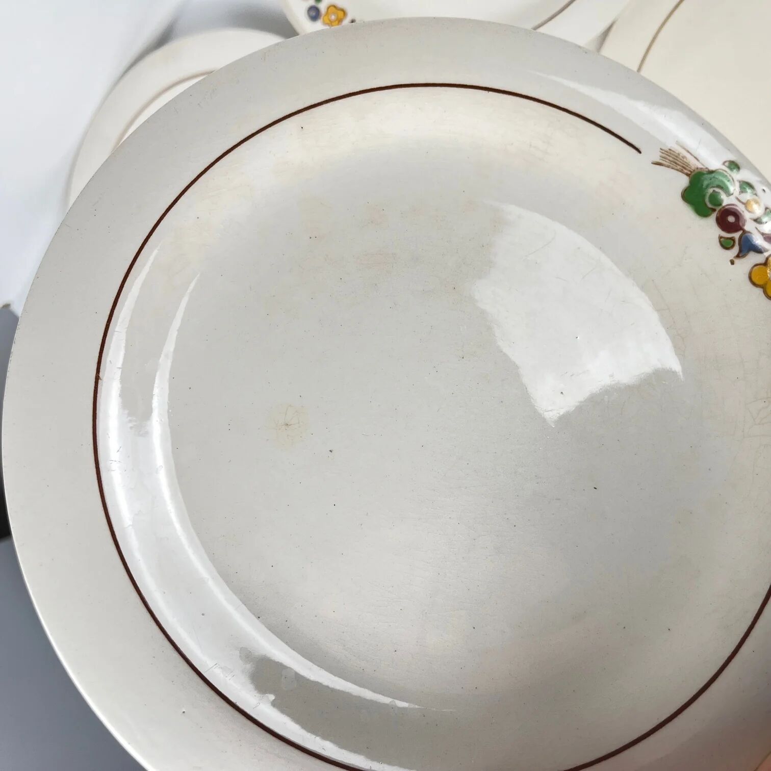 Set of 10 flat plates Longwy, 20th century, floral decoration.