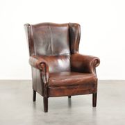 Vintage sheepskin wingback armchair in a deep brown colour finished