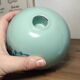 Floral candle holder in enamelled metal