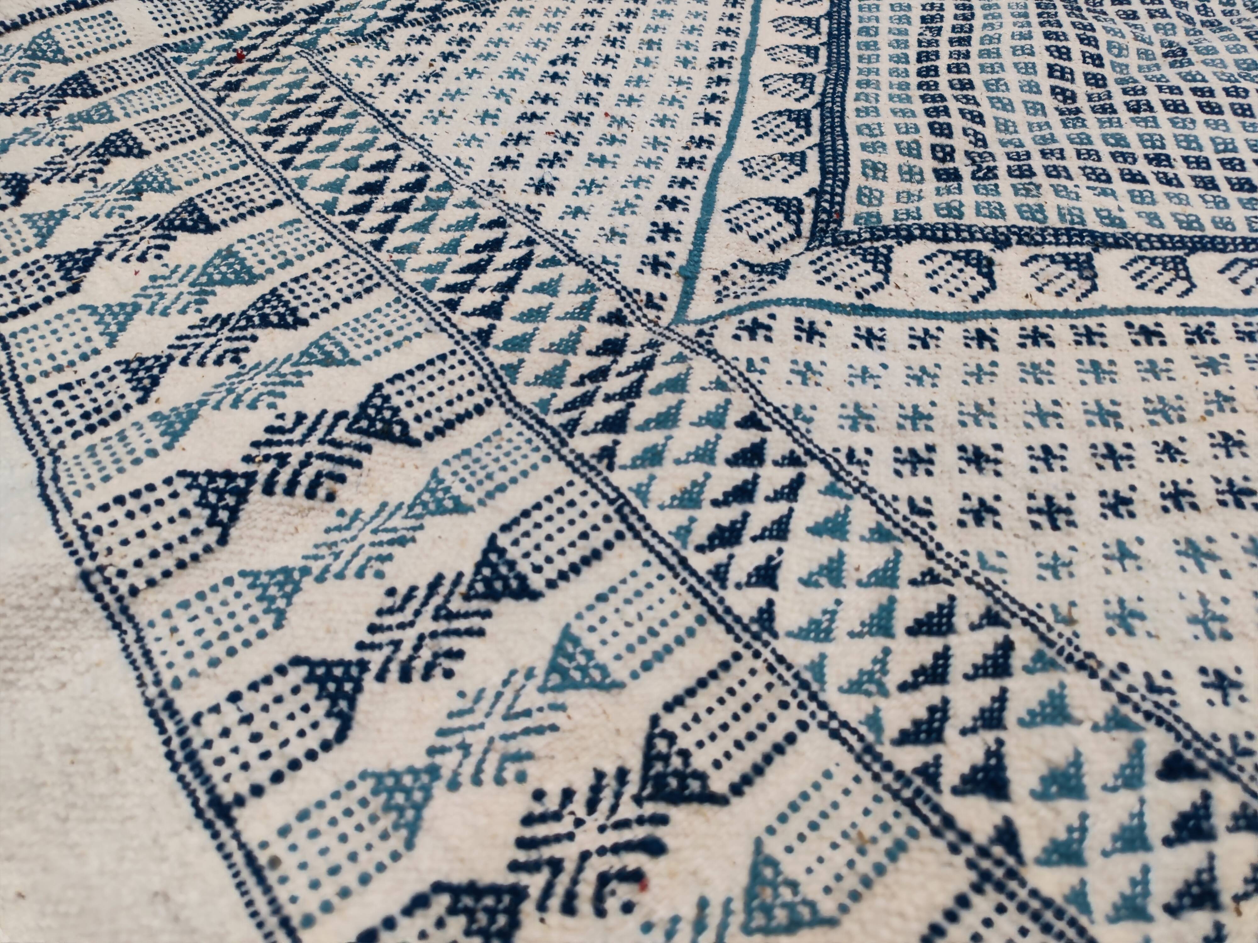 White and blue handwoven rug in natural wool