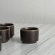 Set of 5 dark brown glazed ceramic egg cups.