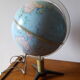 Bright vintage Earth globe brand Vulliermes with metal tripod foot