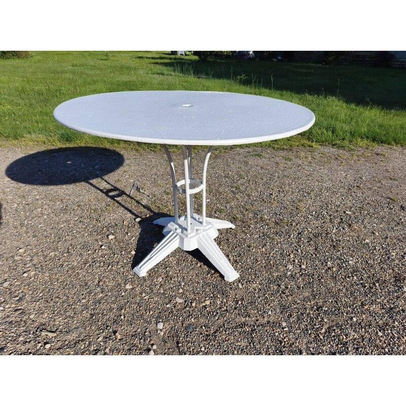 Garden table with a cast iron base and a metal top.