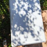 Small white and speckled gray industrial style enameled piece of furniture