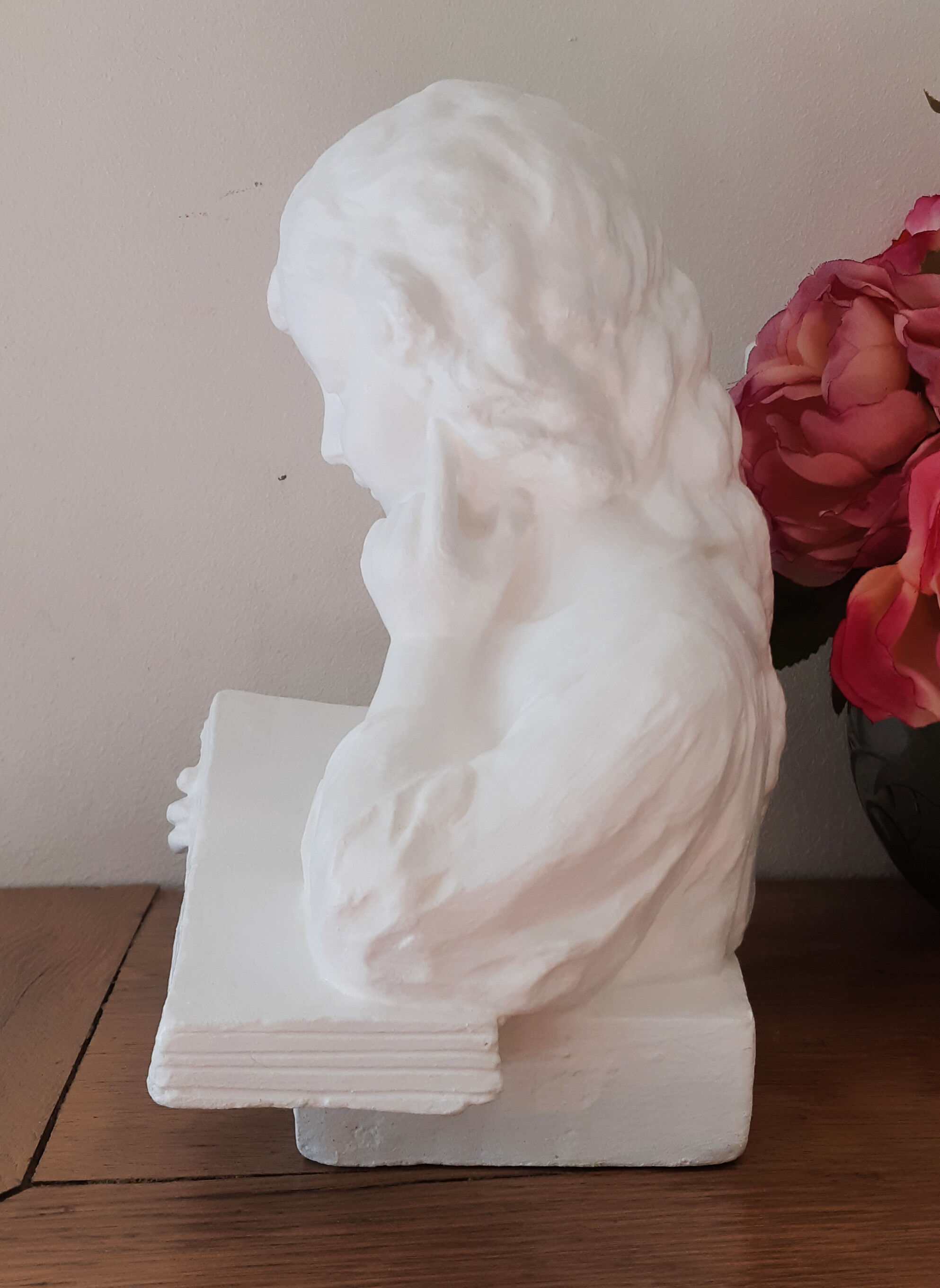 Plaster bust reading child