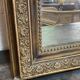 Miroir de cheminée - bois vernis et stuc doré à décor de palmettes