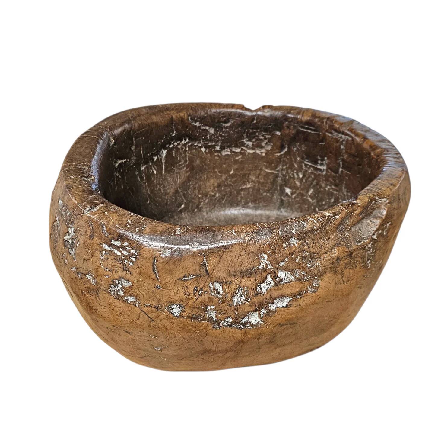 A substantial hand-hewn wooden bowl carved from a single burl section