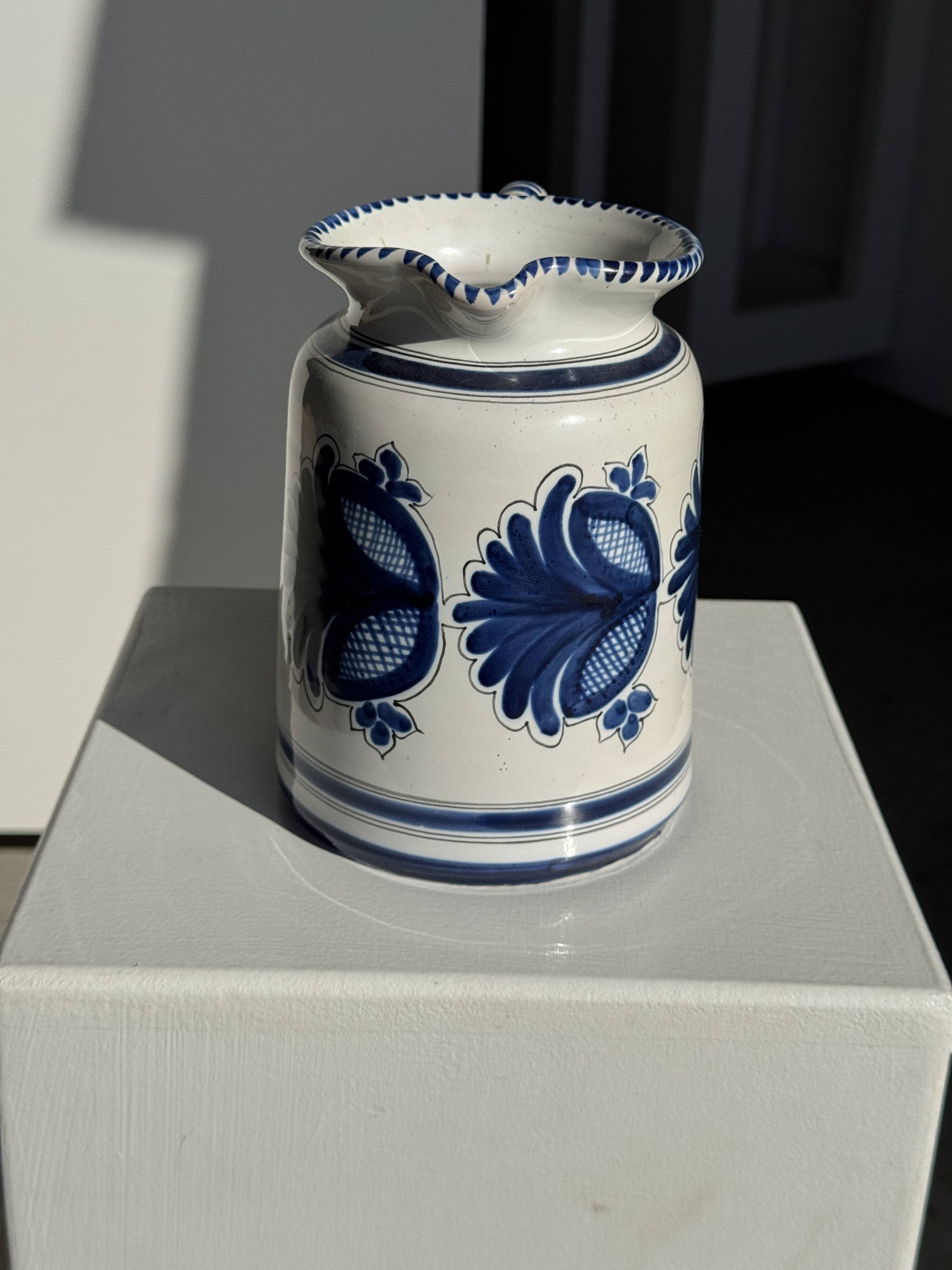 Artisan blue floral decorative carafe, height 17 cm, diameter 24.5 cm.