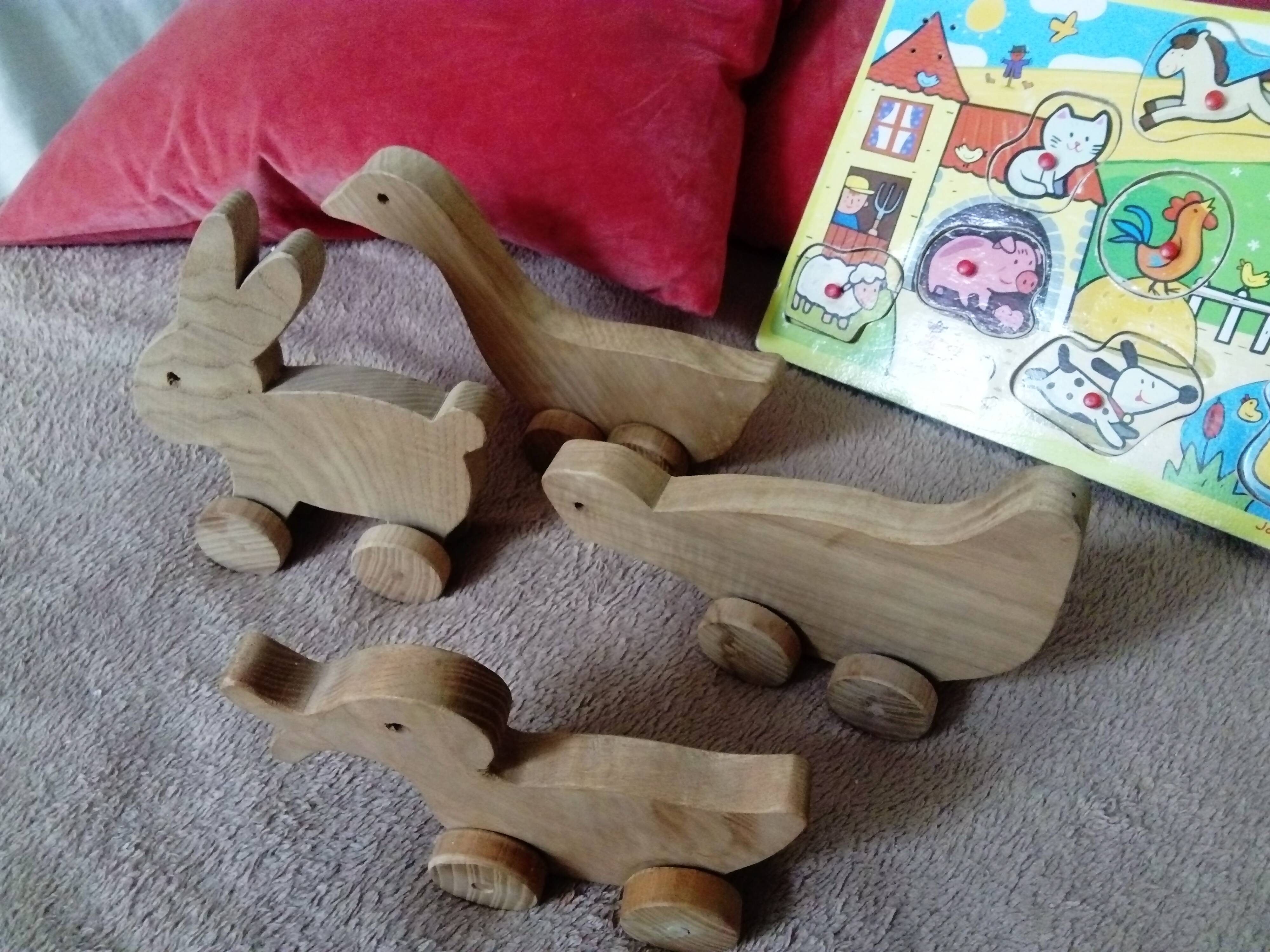 set of 4 wooden toys on wheels