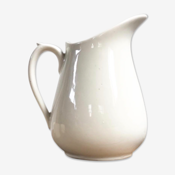 Old pitcher in white earthenware