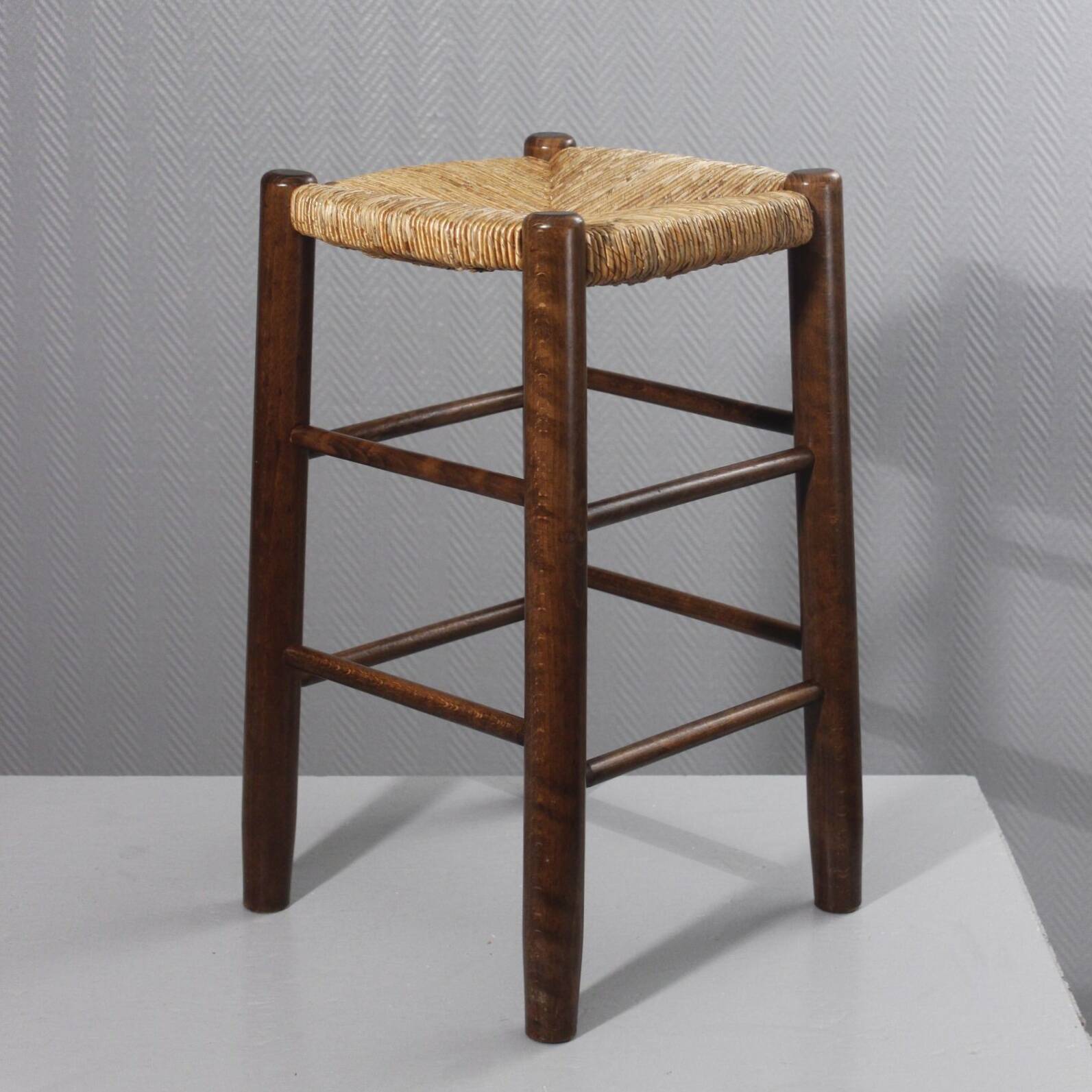 Vintage straw stool in the style of Charlotte Perriand, 1970s.