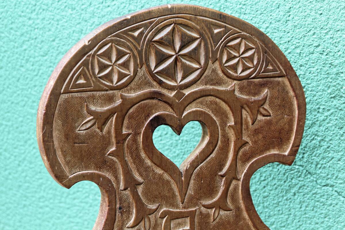 Old Swiss escabelle chair in carved wood