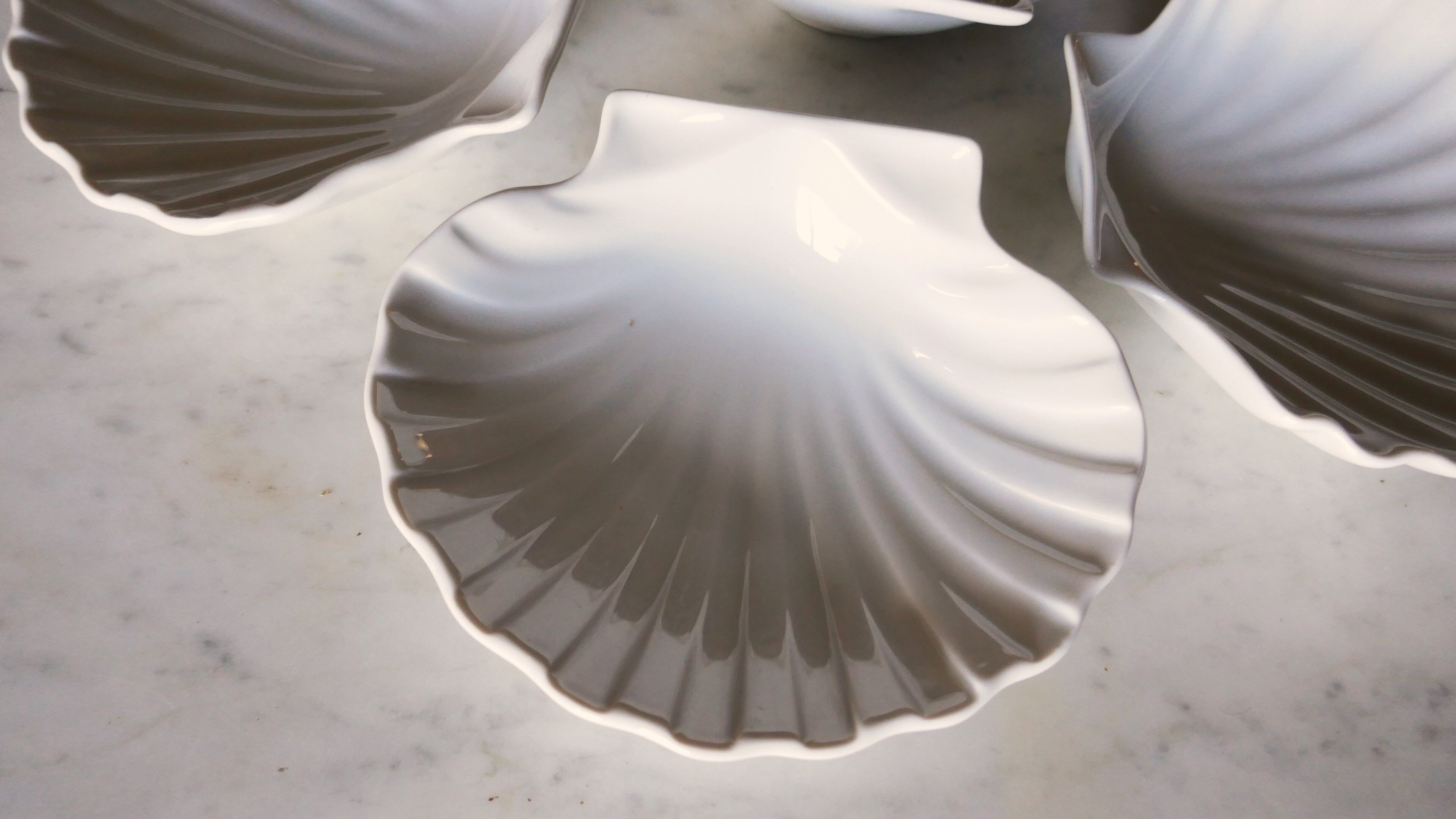 4 antique cups in the shape of a white porcelain shell