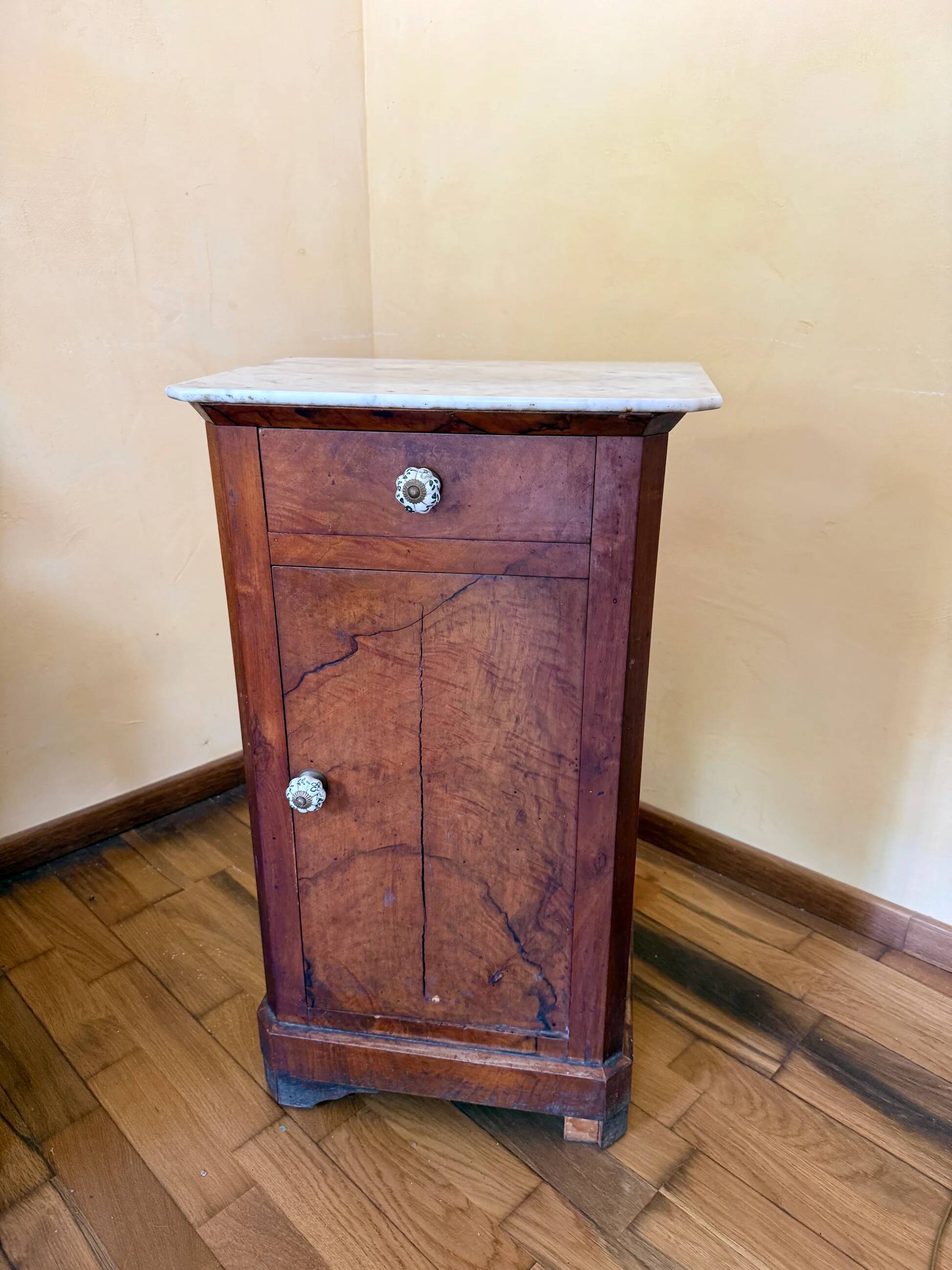 Wood and marble side table with ceramic handles.