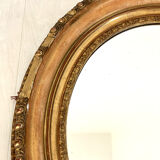 Oval mirror in wood and gilded stucco
