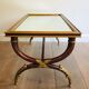 Coffee table in patinated and gilded carved wood with mirror top