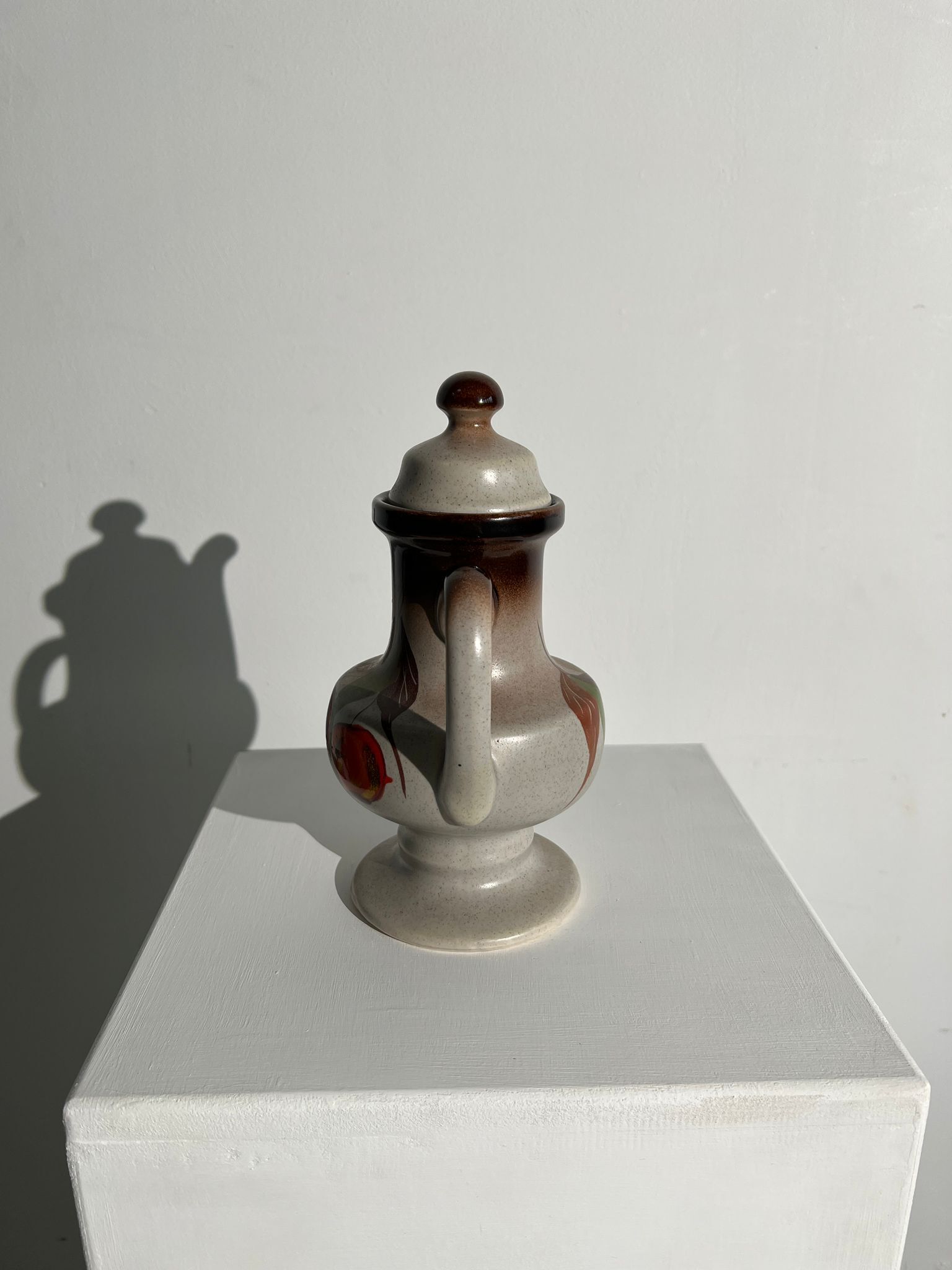 Vintage stoneware teapot with flower and fruit patterns