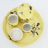 A yellow Art Deco ceramic tobacco service decorated with thistles from the 1920s to 1930s.