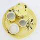 A yellow Art Deco ceramic tobacco service decorated with thistles from the 1920s to 1930s.