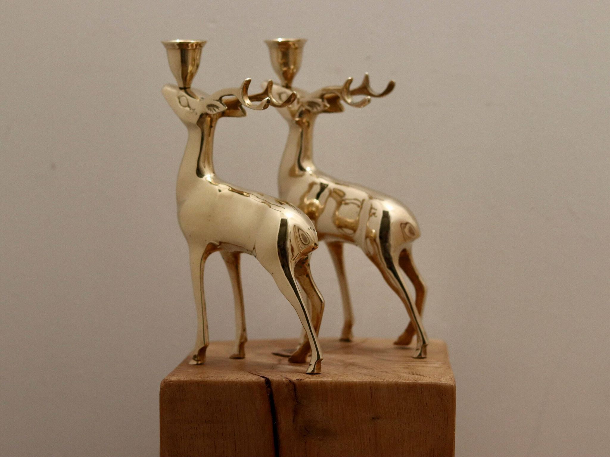 Pair of brass candle holders in the shape of deer from the mid-century.
