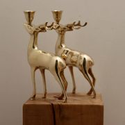 Pair of brass candle holders in the shape of deer from the mid-century.