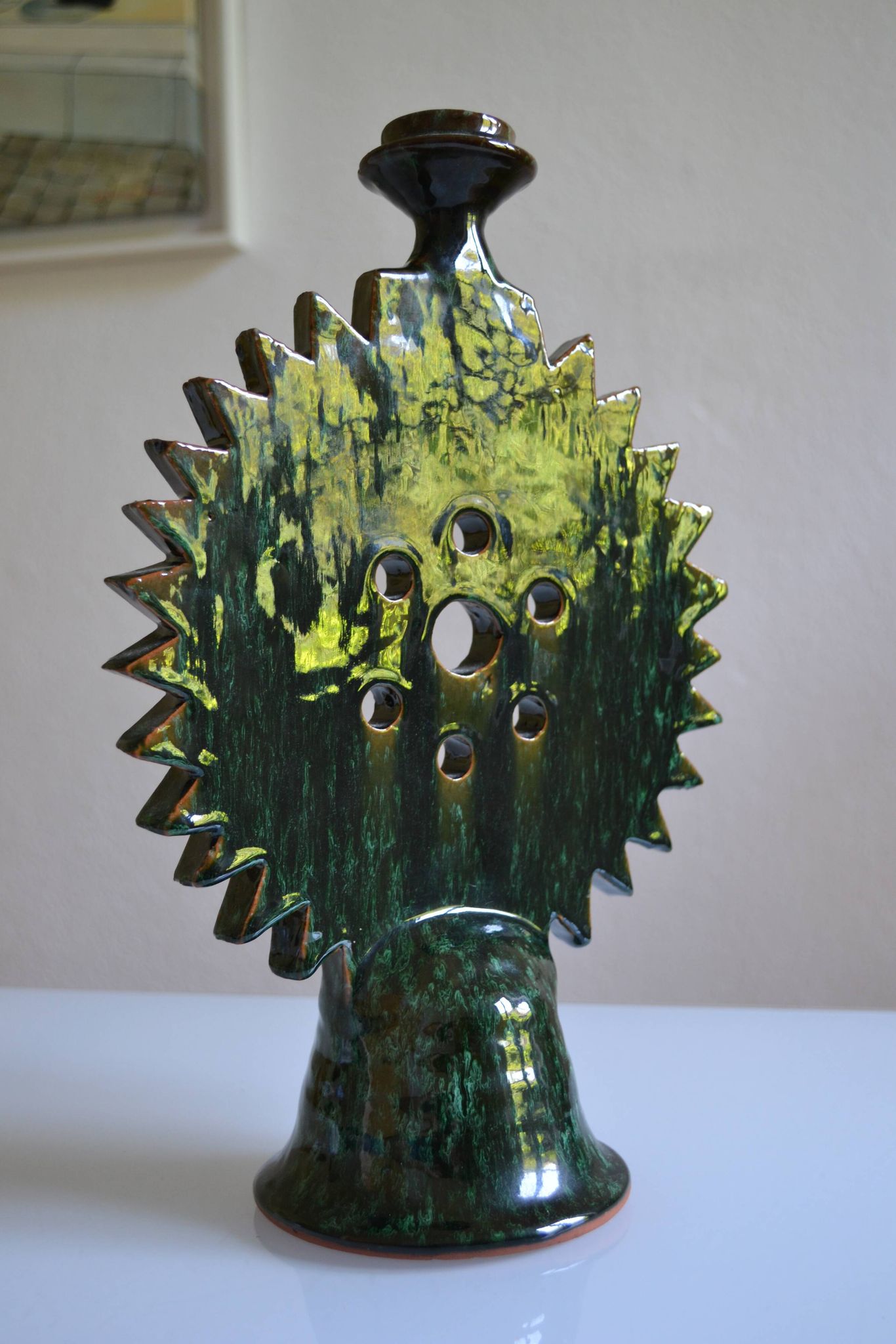 Green ceramic sun candlestick from Tamegroute, Morocco.