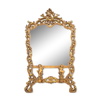 A large mirror in a gold frame, Italy, first half of the 20th century.